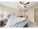 Comfortable bedroom features neutral tones, a ceiling fan, and soft natural light from a bright window at 215 Semel Nw Dr # 455, Atlanta, GA 30309