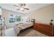 Cozy bedroom featuring neutral tones, a ceiling fan, and a view of the outdoors from a bright window at 215 Semel Nw Dr # 455, Atlanta, GA 30309