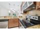 A functional kitchen space featuring stainless steel appliances, granite countertops, and a breakfast bar overlooking living spaces at 215 Semel Nw Dr # 455, Atlanta, GA 30309