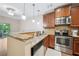 A functional kitchen space featuring stainless steel appliances, granite countertops, and a breakfast bar overlooking living spaces at 215 Semel Nw Dr # 455, Atlanta, GA 30309