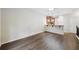 Open-concept living space featuring hardwood floors, with a bar-top dining area creating an inviting atmosphere at 215 Semel Nw Dr # 455, Atlanta, GA 30309
