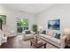 Bright living room with hardwood floors, neutral decor, and a balcony offering relaxing views and fresh air at 215 Semel Nw Dr # 455, Atlanta, GA 30309