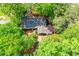 An aerial view of a charming single-story home with a dark roof surrounded by lush green trees at 2840 Wendy Ln, Marietta, GA 30062