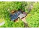 An aerial view of a charming single-story home with a dark roof surrounded by lush green trees at 2840 Wendy Ln, Marietta, GA 30062