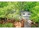 Elevated view of the white brick home surrounded by lush greenery at 2840 Wendy Ln, Marietta, GA 30062