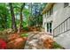 Private outdoor space with a stone patio surrounded by lush greenery and colorful landscaping at 2840 Wendy Ln, Marietta, GA 30062