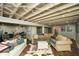 Cozy finished basement area featuring painted ceilings, concrete floors and comfortable seating at 2840 Wendy Ln, Marietta, GA 30062