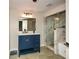 A bathroom featuring a blue vanity, modern fixtures, and a frameless glass shower at 2840 Wendy Ln, Marietta, GA 30062