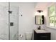 Bright bathroom featuring a glass shower, updated vanity, and natural light from the window at 2840 Wendy Ln, Marietta, GA 30062