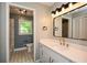 This bathroom features a white vanity, stylish mirror and a doorway to the bath and toilet at 2840 Wendy Ln, Marietta, GA 30062