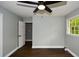 This cozy bedroom features wood floors, a ceiling fan and a window for natural light at 2840 Wendy Ln, Marietta, GA 30062