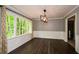 Open dining area with stylish lighting, hardwood floors, and large windows at 2840 Wendy Ln, Marietta, GA 30062