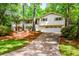 Inviting home with a well-maintained lawn, attached garage, and mature trees, offering a blend of comfort and charm at 2840 Wendy Ln, Marietta, GA 30062