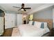 Main bedroom boasts hardwood floors, ceiling fan, and adjacent bathroom at 2840 Wendy Ln, Marietta, GA 30062