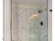 Updated shower with modern fixtures, glass door, and marble-look tile for a spa-like feel at 2840 Wendy Ln, Marietta, GA 30062