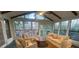 Bright sunroom with a vaulted ceiling, featuring ample seating and scenic views through large windows at 2840 Wendy Ln, Marietta, GA 30062