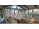 Bright sunroom with a vaulted ceiling, featuring ample seating and scenic views through large windows at 2840 Wendy Ln, Marietta, GA 30062