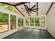 Beautiful sunroom with exposed beams, tile floors, and large windows with wooded view at 2840 Wendy Ln, Marietta, GA 30062