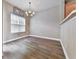 Bright dining area offers hardwood floors, a modern light fixture, and a window with natural light at 319 Franklin Ln, Acworth, GA 30102