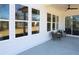 This covered patio features a ceiling fan, large windows, and comfortable seating to relax and enjoy the view at 3552 Cedarvale Ct, Powder Springs, GA 30127