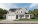 Charming two-story home with a welcoming front porch, white accents, and a two-car garage at 3552 Cedarvale Ct, Powder Springs, GA 30127