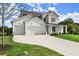 Elegant home with a pristine lawn, featuring a 3 car garage and a cozy covered front porch at 3552 Cedarvale Ct, Powder Springs, GA 30127