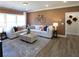 A modern living room features a large sectional couch, a coffee table, and wood floors at 3552 Cedarvale Ct, Powder Springs, GA 30127