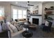 Comfortable living room featuring large windows, a fireplace, and stylish furnishings at 3552 Cedarvale Ct, Powder Springs, GA 30127
