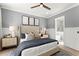Main bedroom with a view to the bathroom and an accent wall at 3552 Cedarvale Ct, Powder Springs, GA 30127