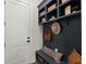 Mudroom with bench, hooks, storage, and a white door at 3552 Cedarvale Ct, Powder Springs, GA 30127