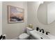 Powder room with a white sink, black faucet, and modern decor at 3552 Cedarvale Ct, Powder Springs, GA 30127