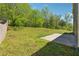 Expansive backyard featuring a stone paver path, a concrete patio, and lush greenery at 5705 Aspen Dr, Cumming, GA 30040