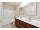 Well-lit bathroom featuring double sink vanity and shower-tub combo at 5705 Aspen Dr, Cumming, GA 30040