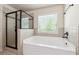 Bathroom featuring soaking tub and glass enclosed shower at 5705 Aspen Dr, Cumming, GA 30040