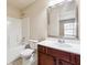 Bathroom featuring a single vanity, a framed mirror, and a bathtub at 5705 Aspen Dr, Cumming, GA 30040