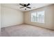 Bright bedroom with plush carpet, ceiling fan, and a window at 5705 Aspen Dr, Cumming, GA 30040