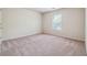 Simple bedroom with neutral carpet, one window, and fresh white walls at 5705 Aspen Dr, Cumming, GA 30040