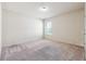 Clean bedroom with neutral carpet, one window, and fresh white walls at 5705 Aspen Dr, Cumming, GA 30040