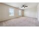 Spacious bedroom features neutral carpet, two windows, and a ceiling fan at 5705 Aspen Dr, Cumming, GA 30040