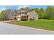 Well-maintained home showcasing a manicured lawn and mature trees in a suburban setting at 5705 Aspen Dr, Cumming, GA 30040