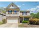 Charming two-story home featuring a stone facade and attached two-car garage at 5705 Aspen Dr, Cumming, GA 30040