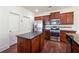 Well-equipped kitchen features stainless steel appliances, granite countertops, and dark wood cabinetry at 5705 Aspen Dr, Cumming, GA 30040