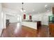 Open kitchen with granite island, stainless appliances, and hardwood floors at 5705 Aspen Dr, Cumming, GA 30040