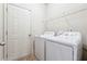 Functional laundry room with appliances and shelving at 5705 Aspen Dr, Cumming, GA 30040