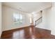 Inviting living room featuring hardwood floors, a large window, and staircase access at 5705 Aspen Dr, Cumming, GA 30040