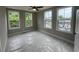 Bright bedroom with ample natural light from three large windows and ceiling fan at 968 Bibbs Circle Nw, Atlanta, GA 30318