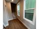Bright hallway featuring hardwood floors, large windows, and a staircase leading to upper levels at 968 Bibbs Circle Nw, Atlanta, GA 30318