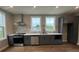 Modern kitchen with stainless steel appliances, sleek countertops, and hardwood floors at 968 Bibbs Circle Nw, Atlanta, GA 30318