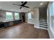 Open-concept living area with hardwood floors, a kitchen, and a staircase at 968 Bibbs Circle Nw, Atlanta, GA 30318