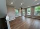 Spacious living area with hardwood floors, large windows, and a ceiling fan at 968 Bibbs Circle Nw, Atlanta, GA 30318
